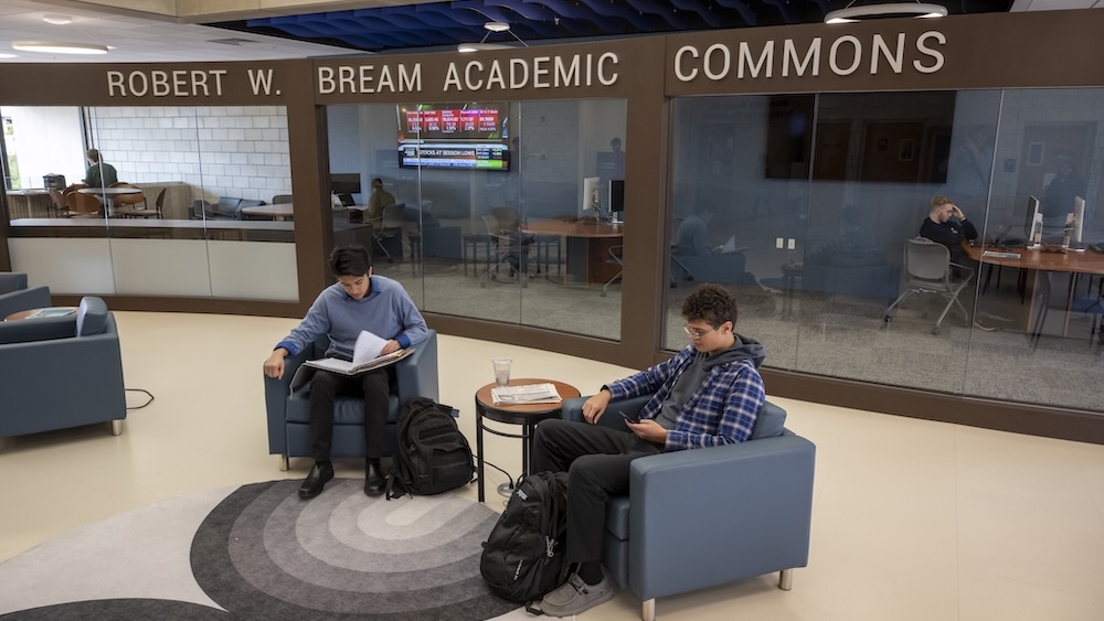student presenting in front of a professor