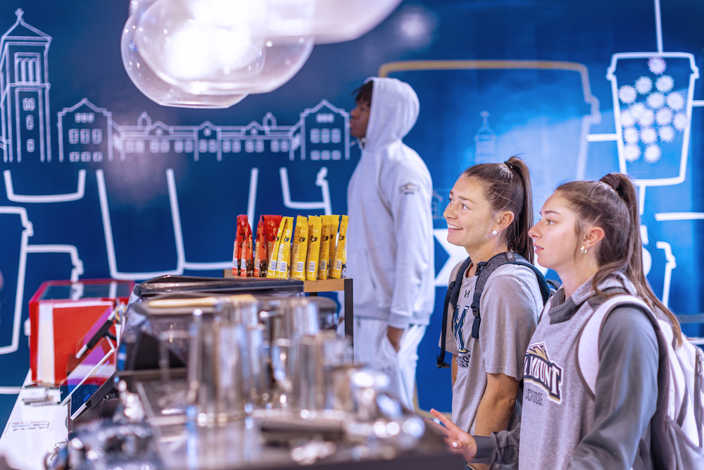 students looking at menu at saxbys